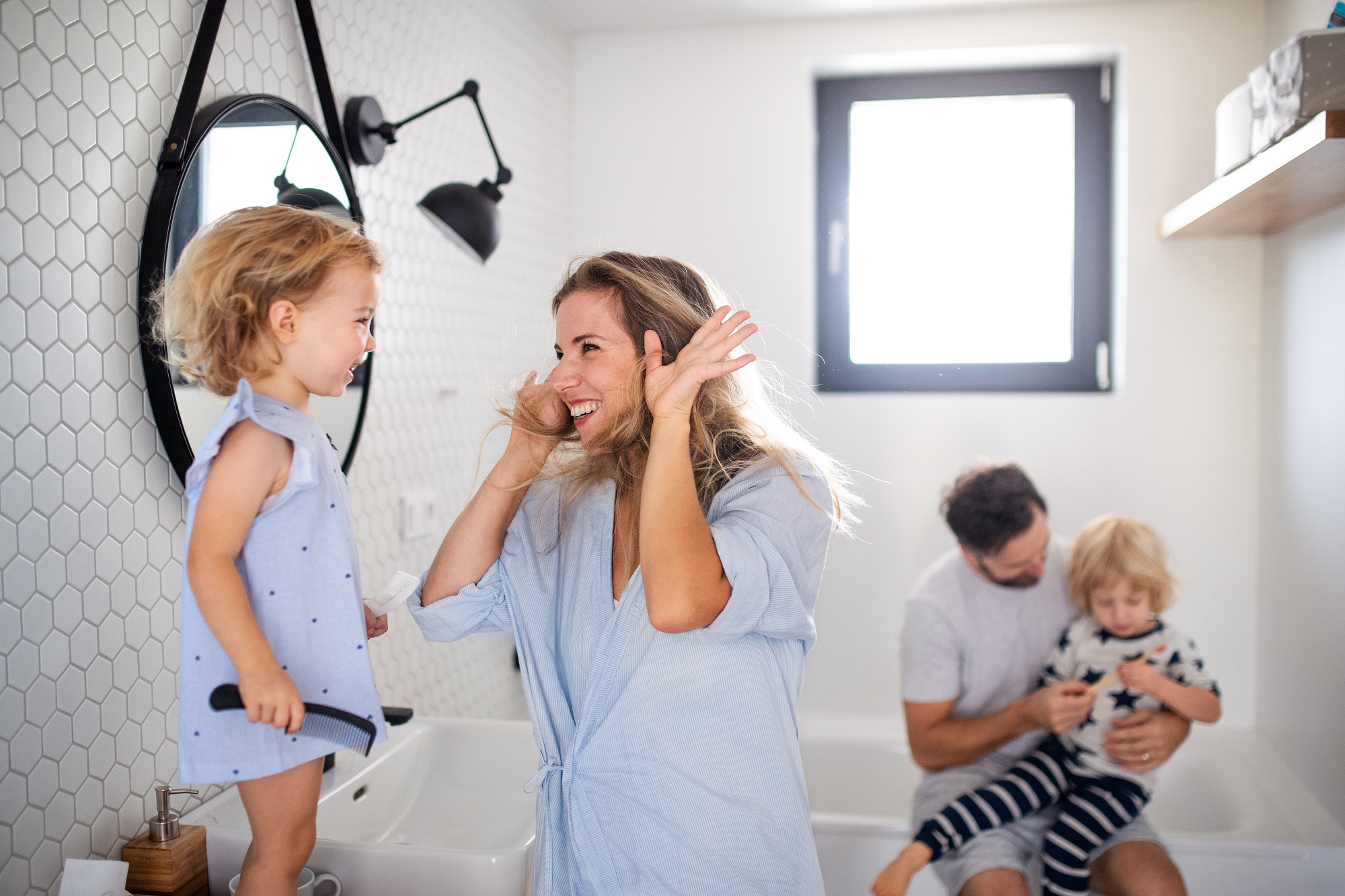 Young family spending time in family bathroom