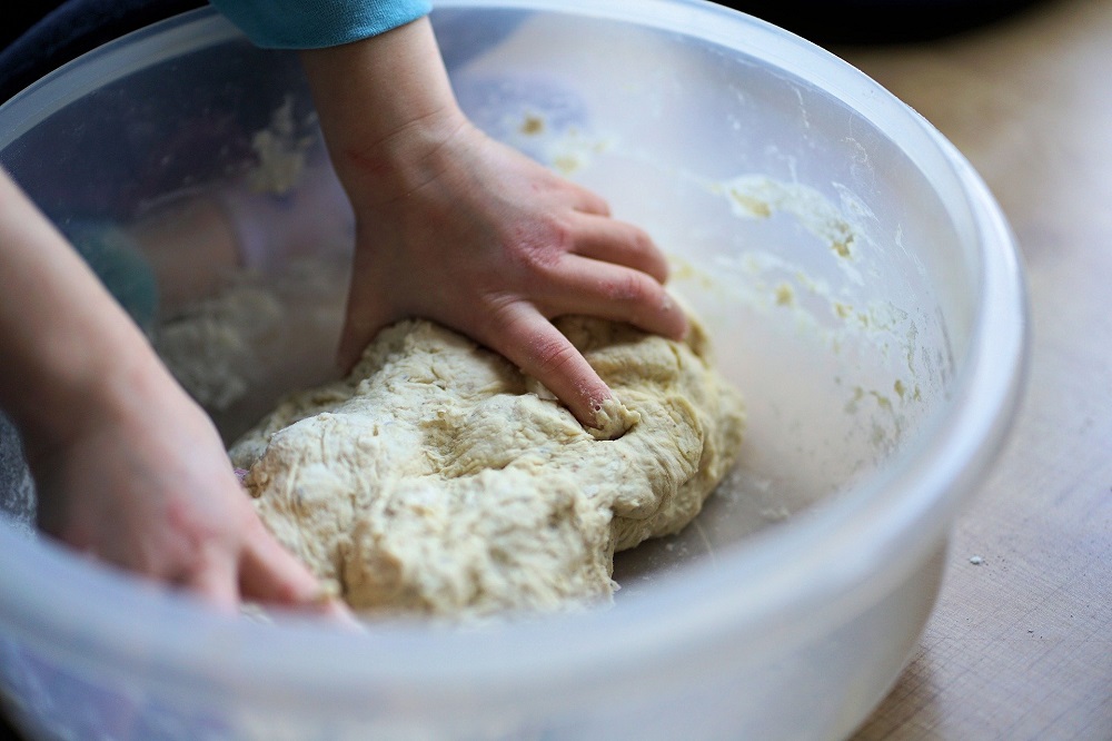 Child making dough