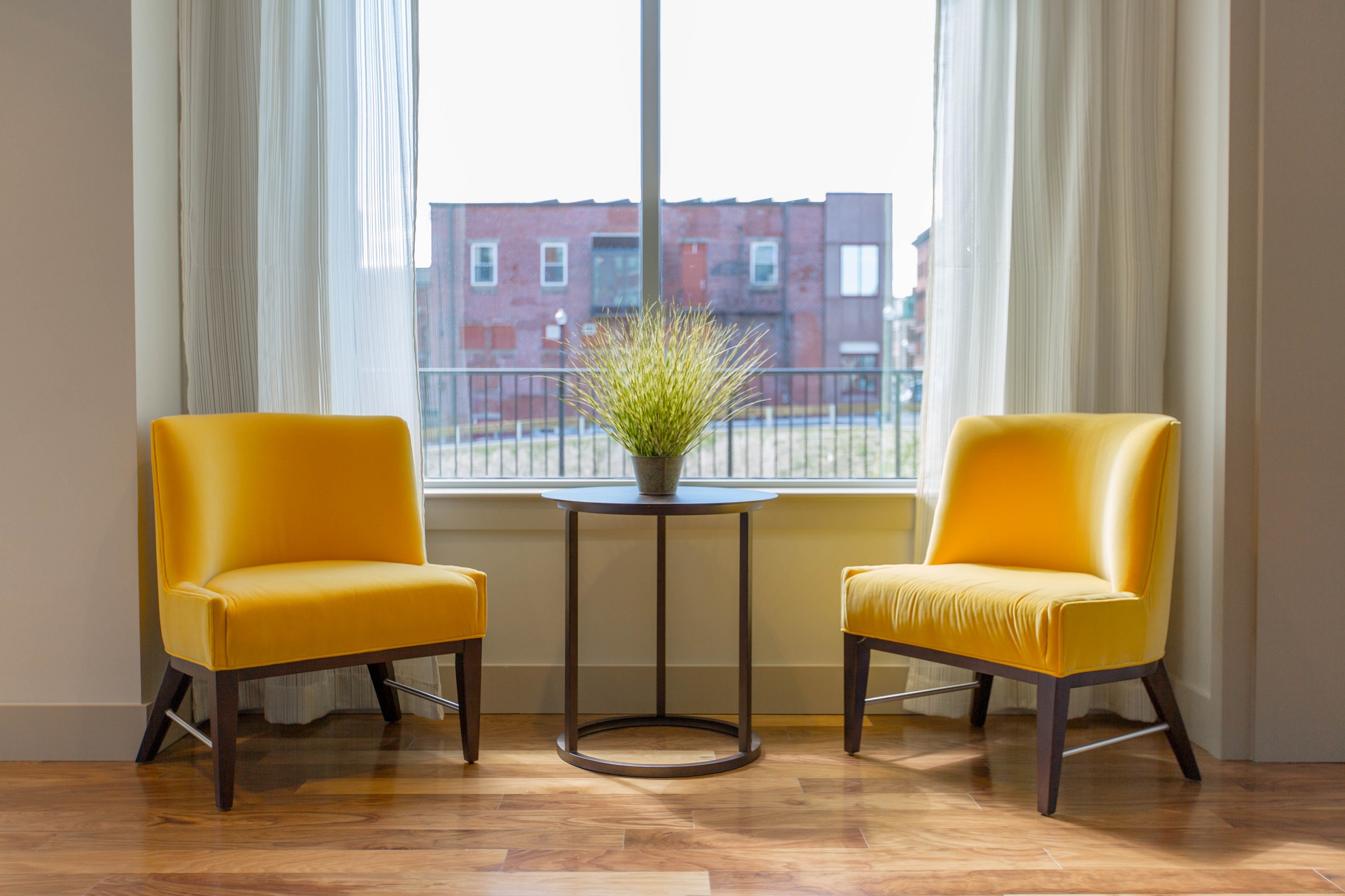 Yellow arm chairs by window